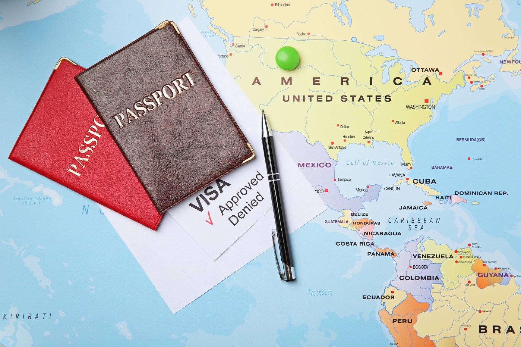 Passports and Pen on Map and Approved American Visa